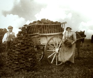 Gathering peat, last century. Not very neat stuff. (Image is public domain)